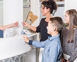 Mother and two children at reception desk