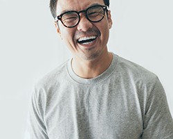 laughing person with glasses