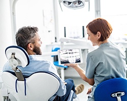 Dentist and patient discussing the cost of dental implant in Highland Park