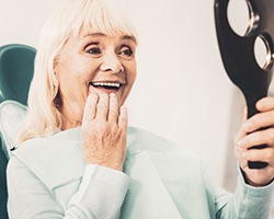 Woman admiring her new dental implants in Highland Park