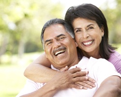 older couple smiling hugging