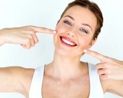 woman pointing to her teeth