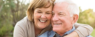 Smiling older man and woman outdoors