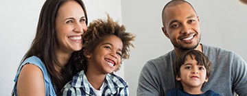 Mother father and two kids smiling together