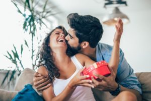 a couple exchanging smile-friendly gifts for Valentine’s Day