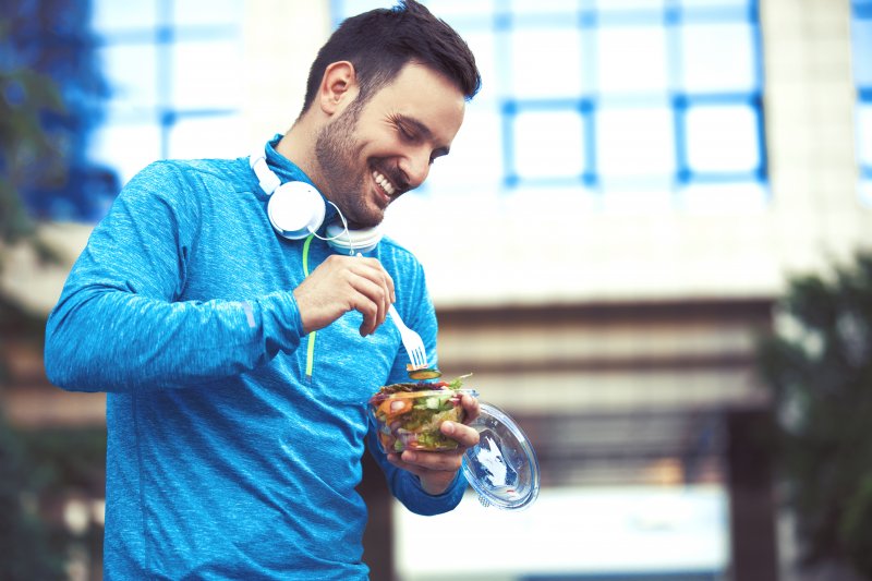 A man with good oral hygiene eating healthy