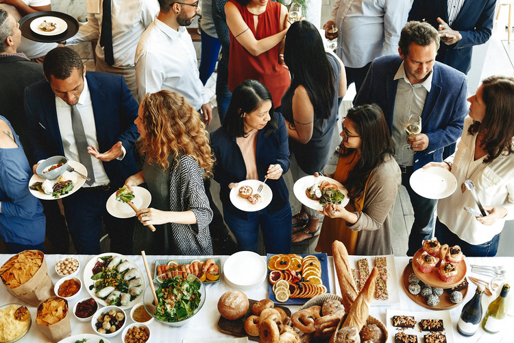 Various people eating food at a holiday party